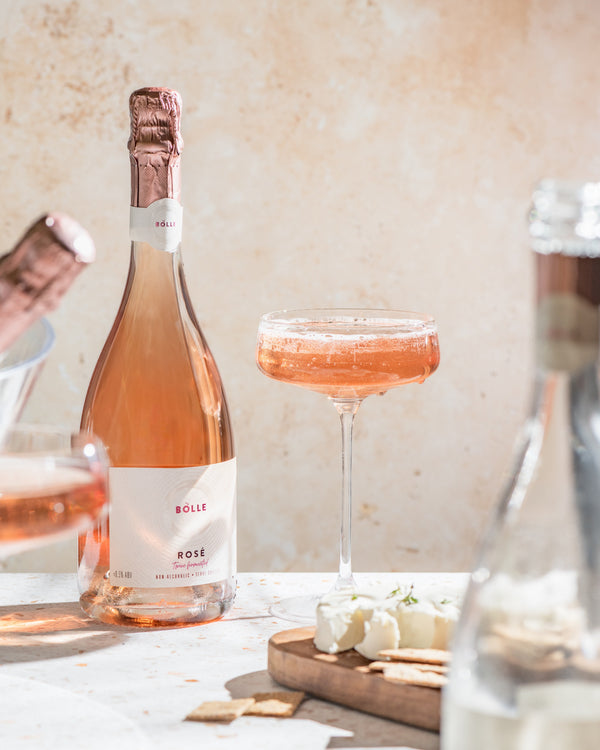 BOLLE Sparkling Rosé in coupe glass with cheese pairing